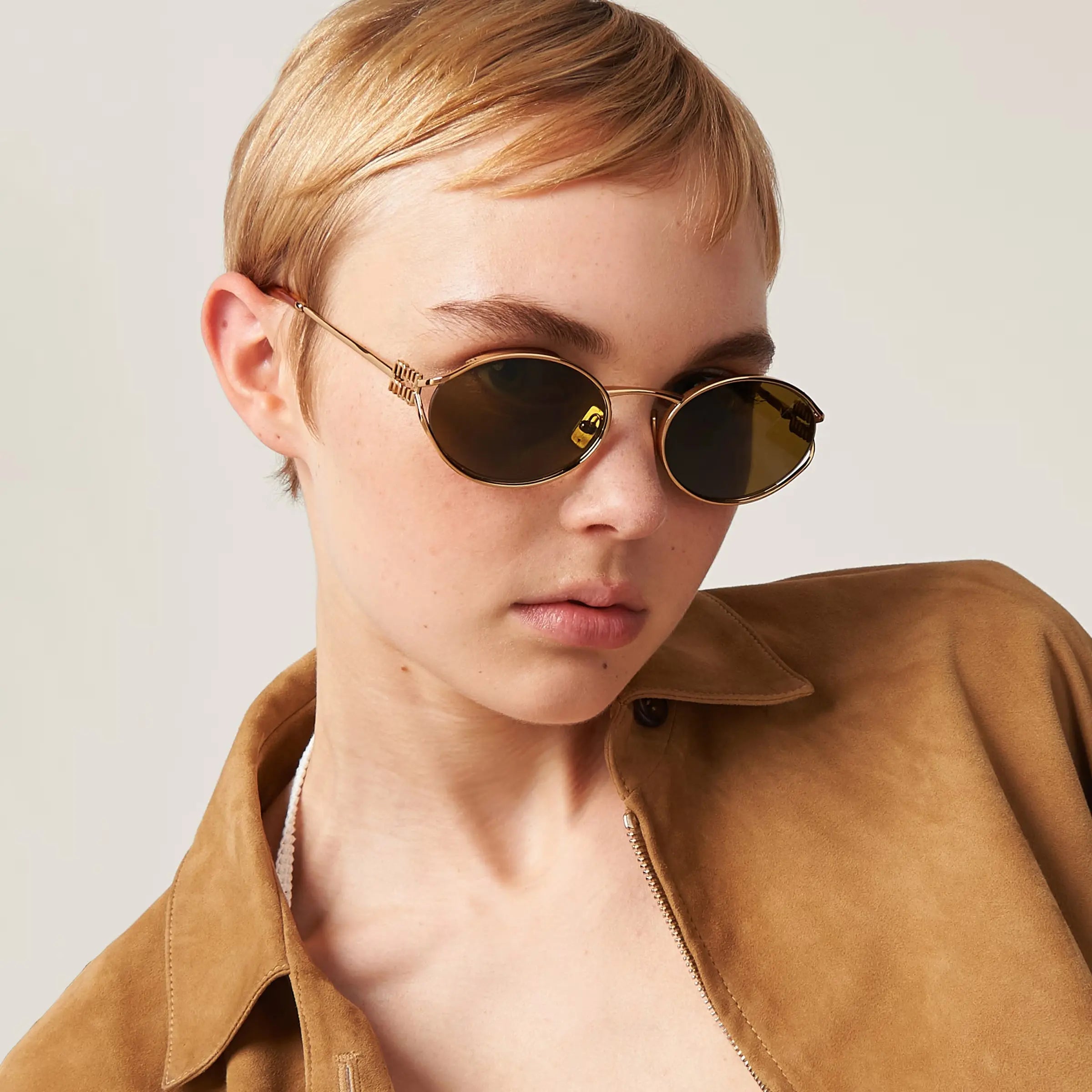 Gold miu miu oval frames with logo arms