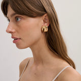 the warped stud in gold