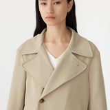 stretch twill coat in light tan close up