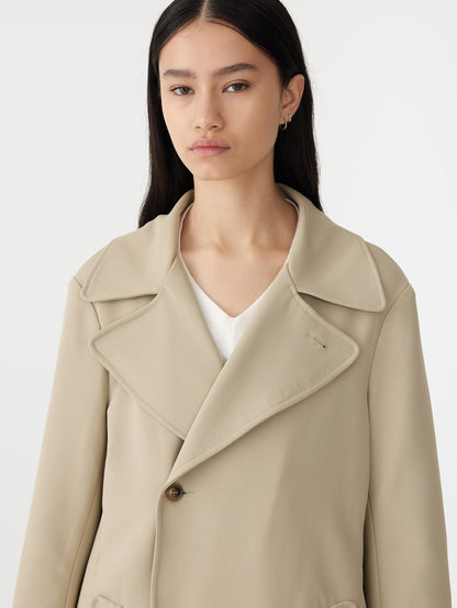 stretch twill coat in light tan close up